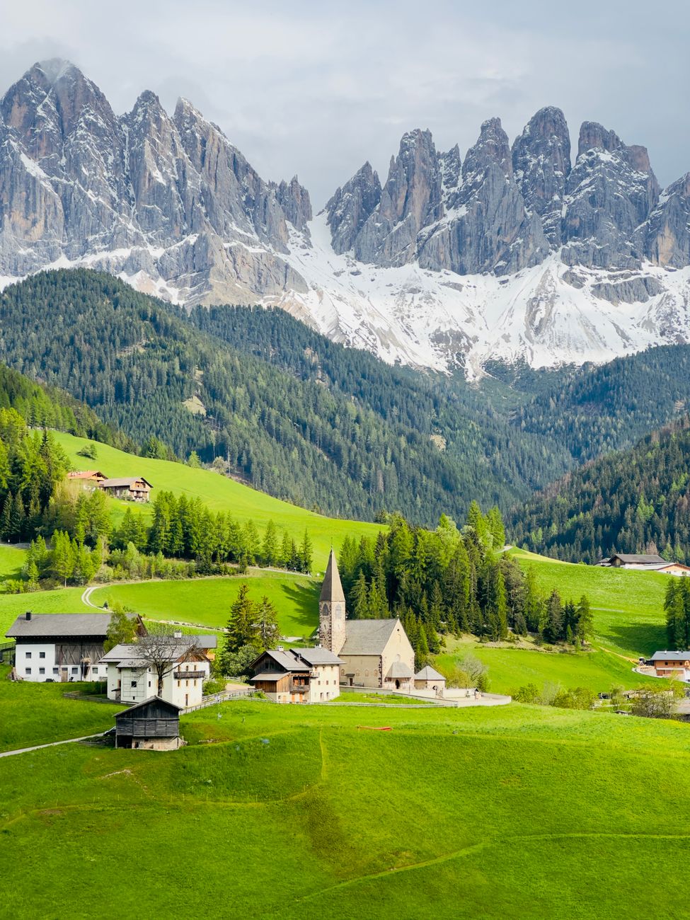 Alpine meadow and solitary stone chapel in Dolomites